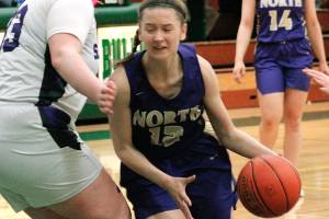 Grace Johnson looks for room against Anacortes forward Melissa Frein. North Kitsap saw its season end with a 65-49 loss. (Mark Krulish/Kitsap News Group)