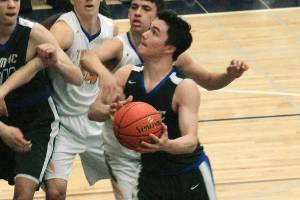 Brandon Barron looks for a path to the hoop during his teams regional game against Fife. (Mark Krulish/Kitsap News Group)