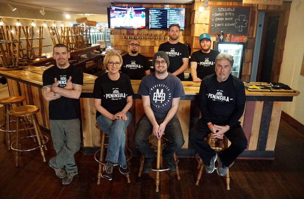 The Peninsula BevCo Collective meet weekly to discuss business matters: (left to right) David Wallis, Sylvia Morgan; Rob Frazer; Cody Morgan; Tanner Mueller; Blake Ecklund and Harlan Morgan (front). Not in the photo: Sara Arrowsmith. (Bob Smith | Kitsap Daily News)