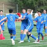 Olympics Josh Frey (center) is mobbed by his teammates after scoring the game-winning goal against Kingston. (Mark Krulish/Kitsap News Group)