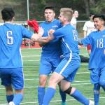 Olympics Josh Frey (center) is mobbed by his teammates after scoring the game-winning goal against Kingston. (Mark Krulish/Kitsap News Group)