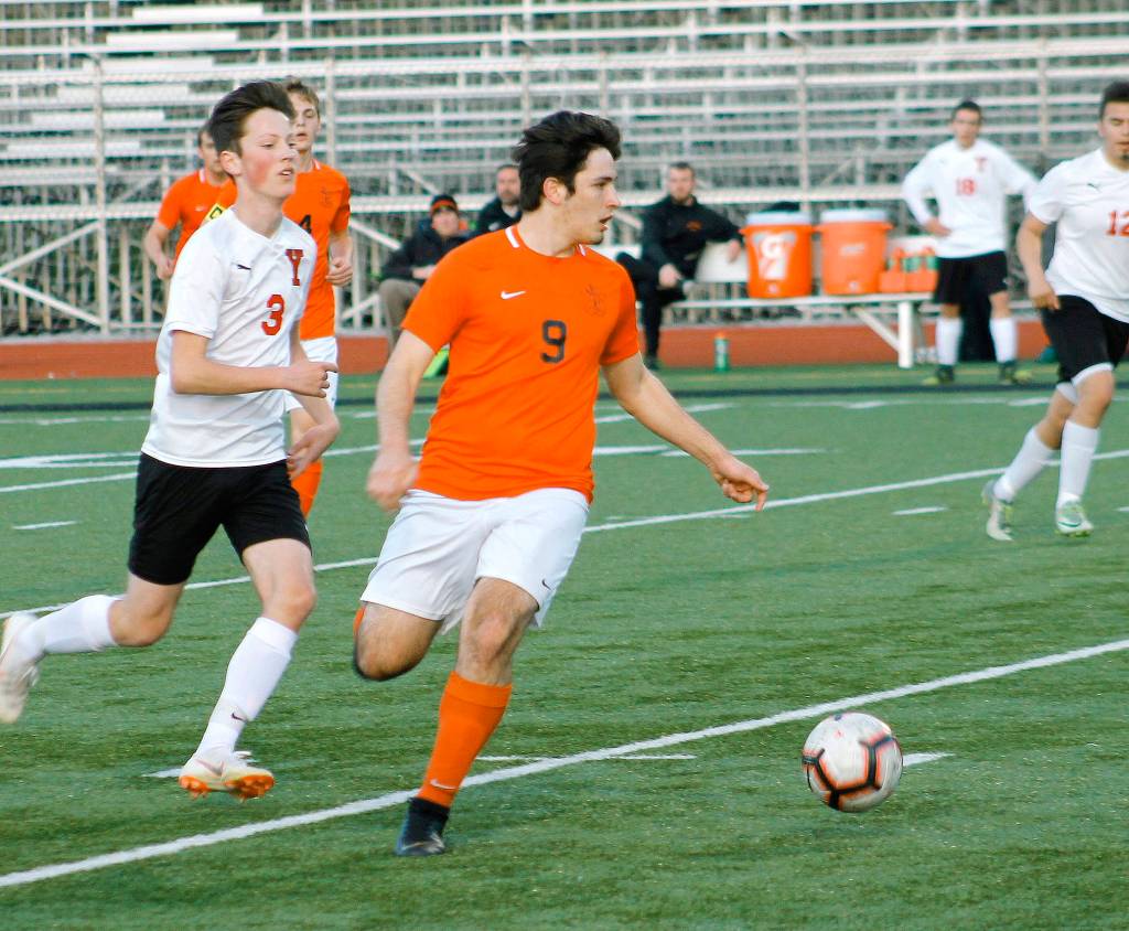 Josh Roche looks for a passing option against Yelm. (Mark Krulish/Kitsap News Group)
