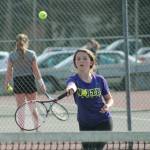 Emma Harper races towards the net against an opponent in a recent singles match. (Mark Krulish/Kitsap News Group)