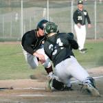 Jacob Duarte dives for the plate in the seventh inning against Emerald Ridge, but a good throw resulted in an out. (Mark Krulish/Kitsap News Group)