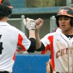 Jaiden Tolentino-Balagtas fist-bumps with Austin McMinds (4) after scoring the final run of the game against Shelton. (Mark Krulish/Kitsap News Group)