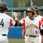 Jaiden Tolentino-Balagtas fist-bumps with Austin McMinds (4) after scoring the final run of the game against Shelton. (Mark Krulish/Kitsap News Group)