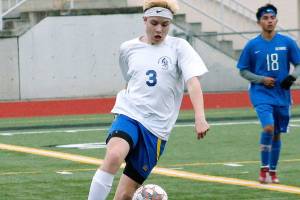 Bremertons Carter Braunz get the ball and looks to turn up field against Olympic. (Mark Krulish/Kitsap News Group)