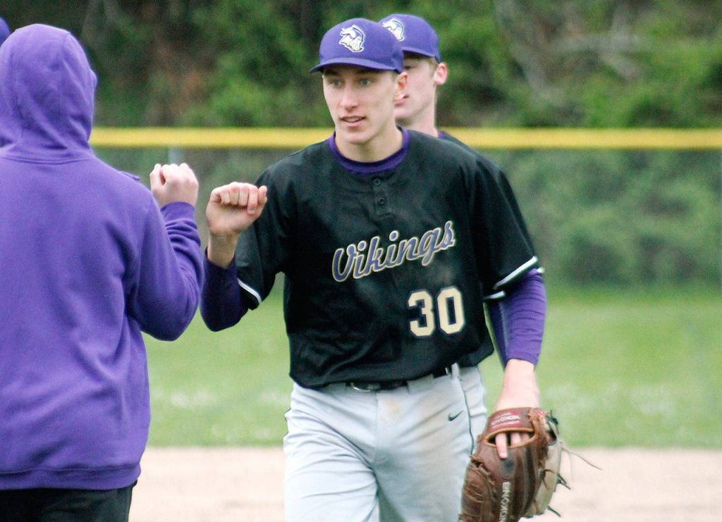 Logan Chmielewski is congratulated after picking up the win against North Mason. He gave up just five hits and two runs in five innings. (Mark Krulish/Kitsap News Group)