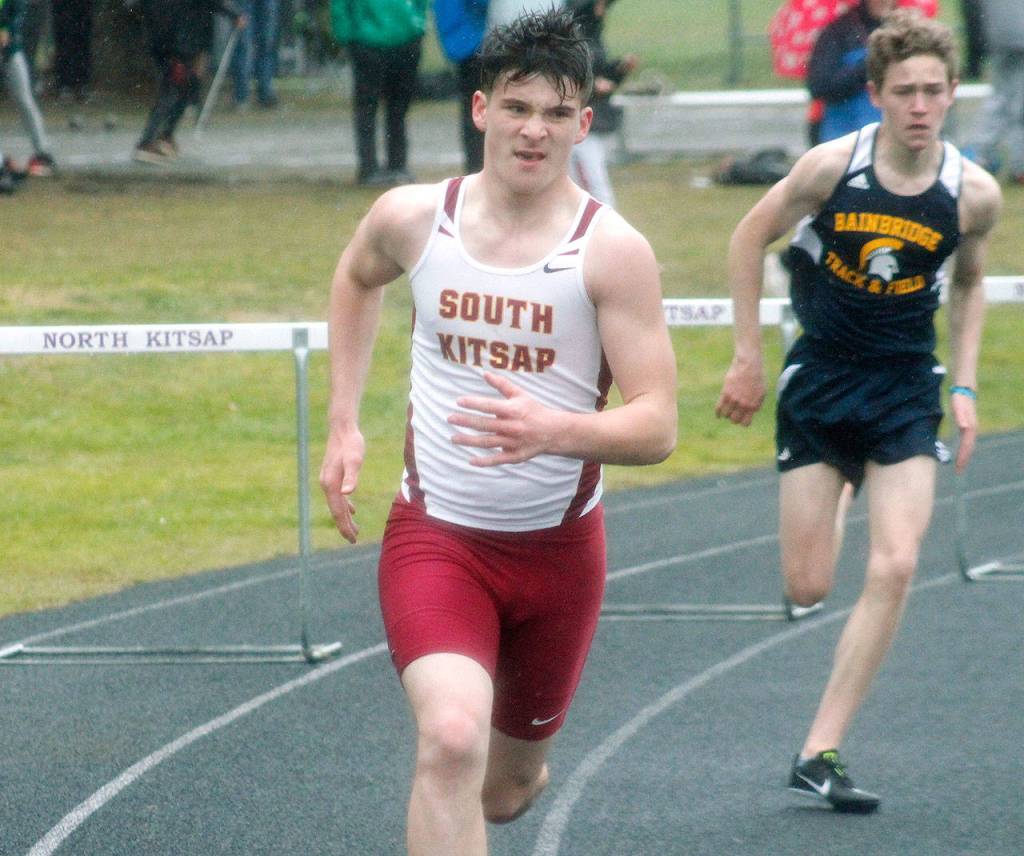 Ryland Pearson makes the turn for South Kitsap in the 300-meter hurdles. (Mark Krulish/Kitsap News Group)
