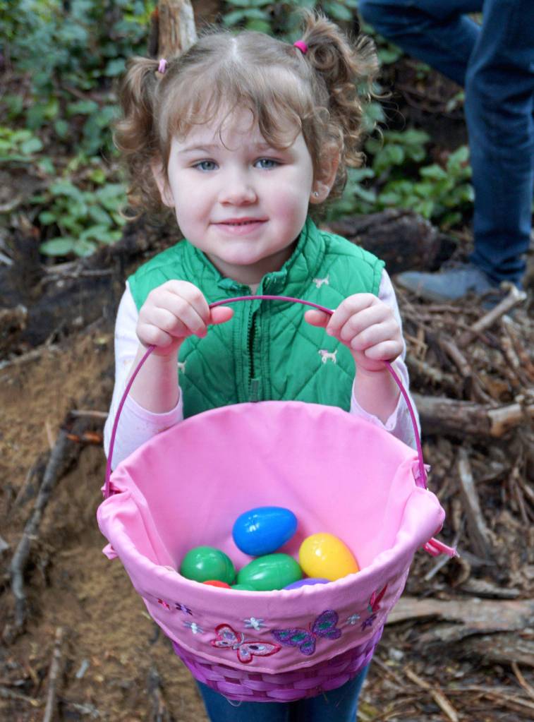 Annabelle Adams, 4, shows off the bounty of her Easter egg hunt Saturday at South Kitsap Regional Park. (Bob Smith | Kitsap Daily News)