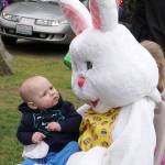 A tiny one gives the Easter Bunny a quizzical glance before Dad takes a photo. (Bob Smith | Kitsap Daily News)