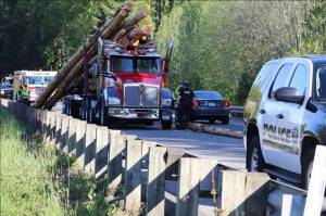 Log truck loses load on Highway 305 causing backup, no injuries reported