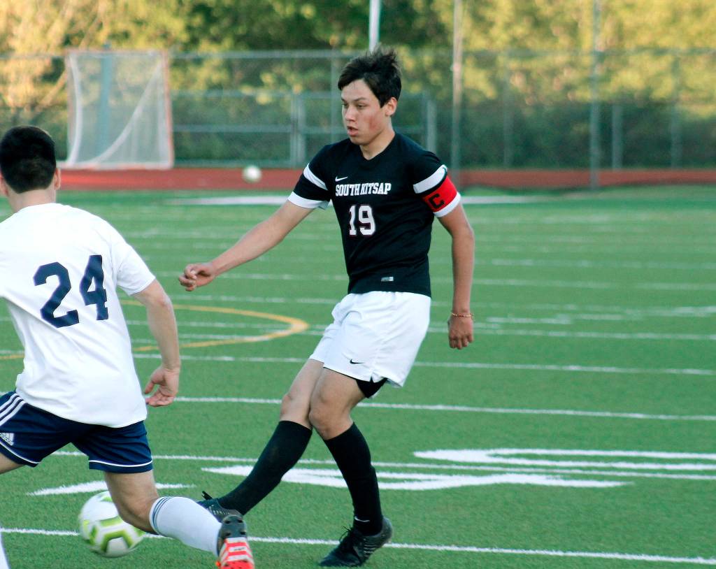 Eduardo De La Cruz tries to slip a ball past a Lions defender. (Mark Krulish/Kitsap News Group)