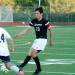Eduardo De La Cruz tries to slip a ball past a Lions defender. (Mark Krulish/Kitsap News Group)