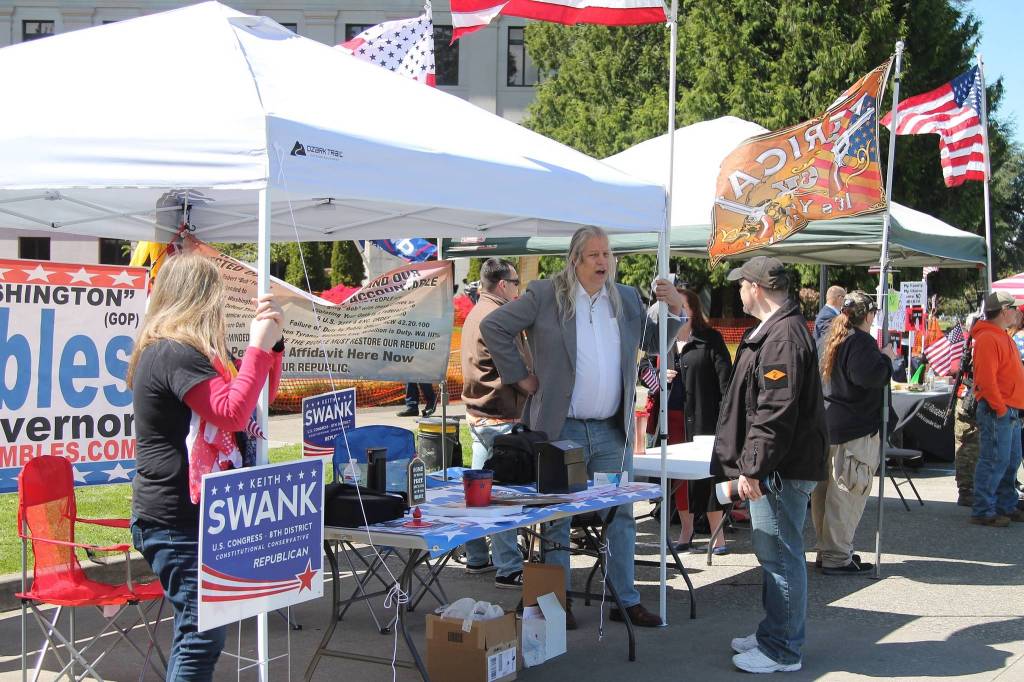 Supporters man the Keith Swank for U.S. Congress booth at the March for Our Rights rally in Olympia on April 27.  Photo by Emma Epperly, WNPA Olympia News Bureau