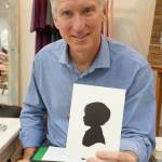 Karl Johnson displays his most recent silhouette creation. (Bob Smith | Kitsap Daily News)