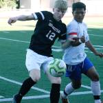 South Kitsaps Logan Anchick battles for a loose ball against a Kent-Meridian defender. (Mark Krulish | Kitsap News Group)