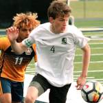 Klahowyas Aaron Becker flips the ball ahead of a Forks player in his teams 1A state tournament game. (Mark Krulish/Kitsap News Group)