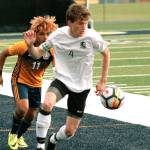Klahowyas Aaron Becker flips the ball ahead of a Forks player in his teams 1A state tournament game. (Mark Krulish/Kitsap News Group)