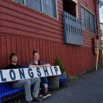 Longship Marine owners Aaron Wenholz and Nico Jensen hold up Longships sign in front of the stores new building just next door to their former location. Nick Twietmeyer / Kitsap News Group