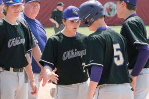 Max Larsen (7) and the rest of the Vikings congratulate Colton Bower on his home run against Sequim in the district playoffs. (Mark Krulish/Kitsap News Group)
