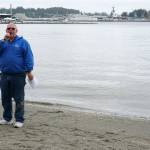 Matt Murphy begins to wrap up the Seagull Calling Contest Saturday just as a seagull straggler steams to shore looking for any remaining treats left by contestants. (Bob Smith | Kitsap Daily News)