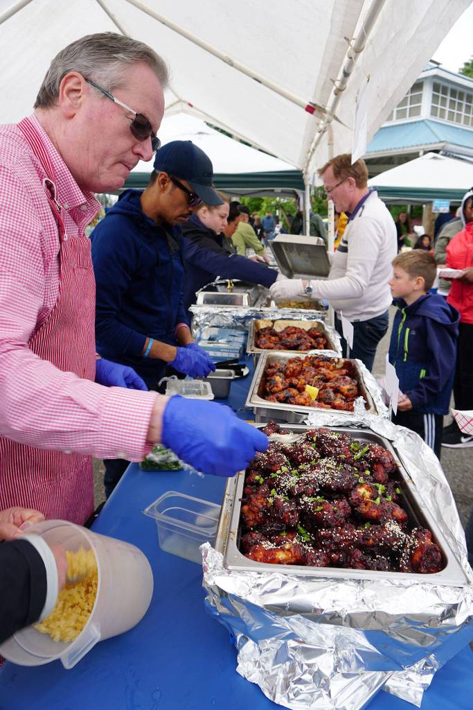 Steve Sego, co-owner of The Dock Bar Eatery, gets ready to serve the restaurants wings entry at the Wings Cook-Off on the Port Orchard waterfront Saturday. (Bob Smith | Kitsap Daily News)