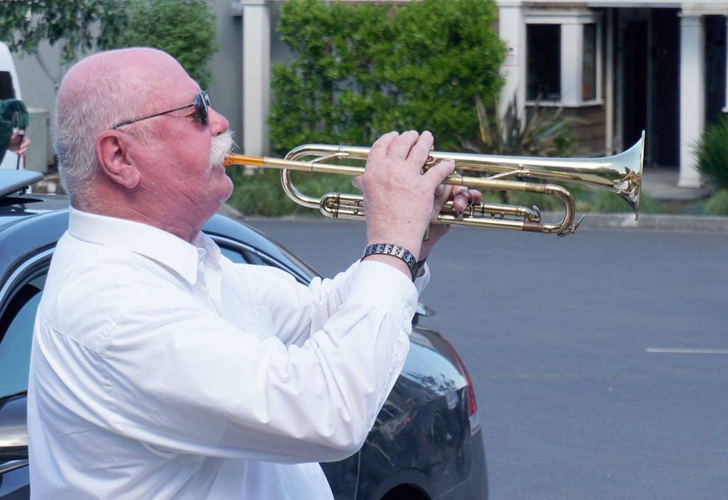 A bugler plays taps at the Manchester Veterans Memorial Observance at the Manchester Community Library on Memorial Day. (Bob Smith | Kitsap Daily News)
