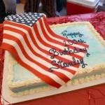 This brightly decorated birthday cake was one of three ready for slicing at the veterans birthday party. (Bob Smith | Kitsap Daily News)