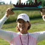 Juli Inkster raises the trophy at the 2019 Suquamish Clearwater Legends Cup. (Mark Krulish/Kitsap News Group)