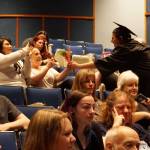 An Explorer Academy graduate presents cut flowers to a significant contributor who helped her achieve her educational goals. (Bob Smith | Kitsap Daily News)