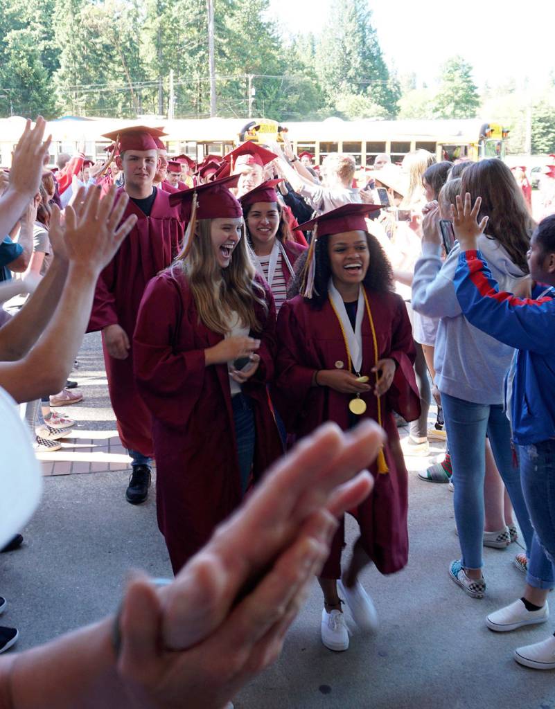 Former Sedgwick Middle School alums and graduating South Kitsap High School seniors walk through a gauntlet of congratulatory Sedgwick students June 11. (Bob Smith | Kitsap Daily News)