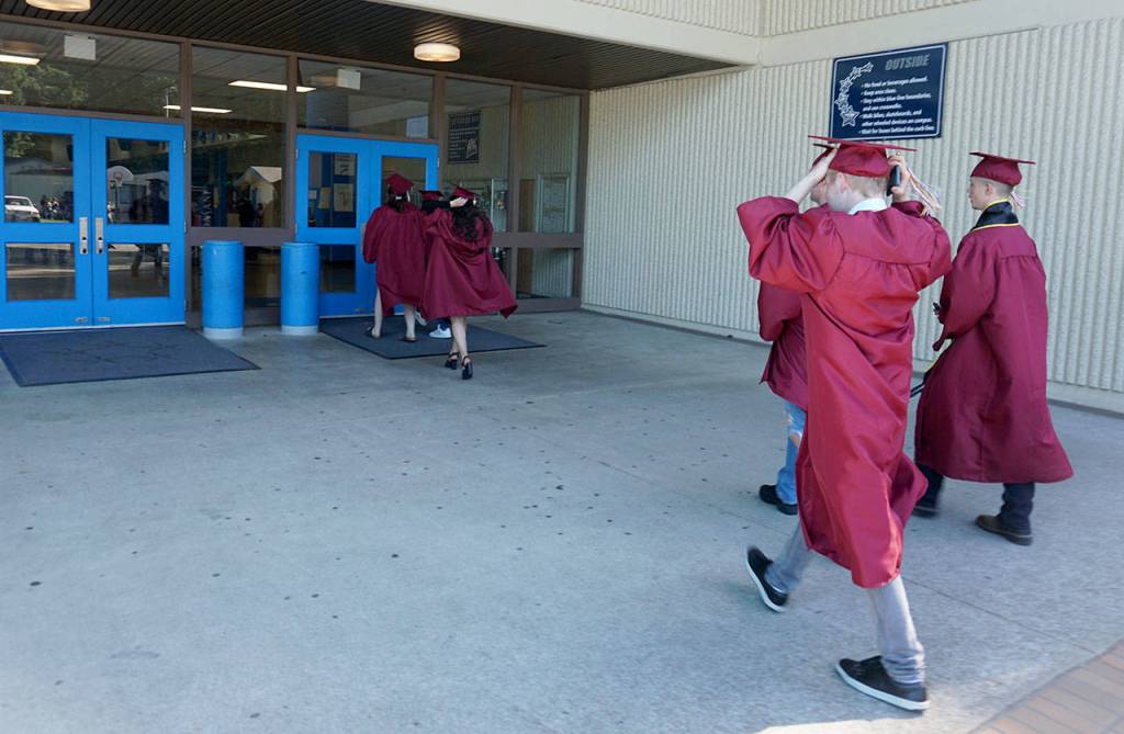 South Kitsap High School graduates prepare to enter their old middle school building during a group visit on June 11. (Bob Smith | Kitsap Daily News)