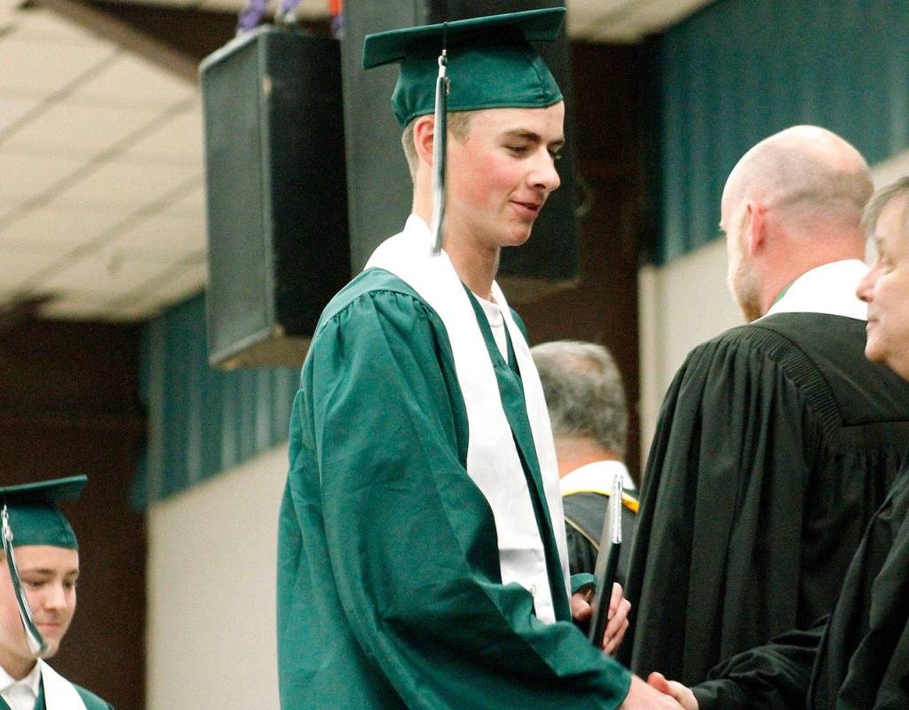 Graduates get their diploma and proceed out. (Mark Krulish/Kitsap News Group)