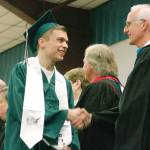 Graduates get their diploma and proceed out. (Mark Krulish/Kitsap News Group)