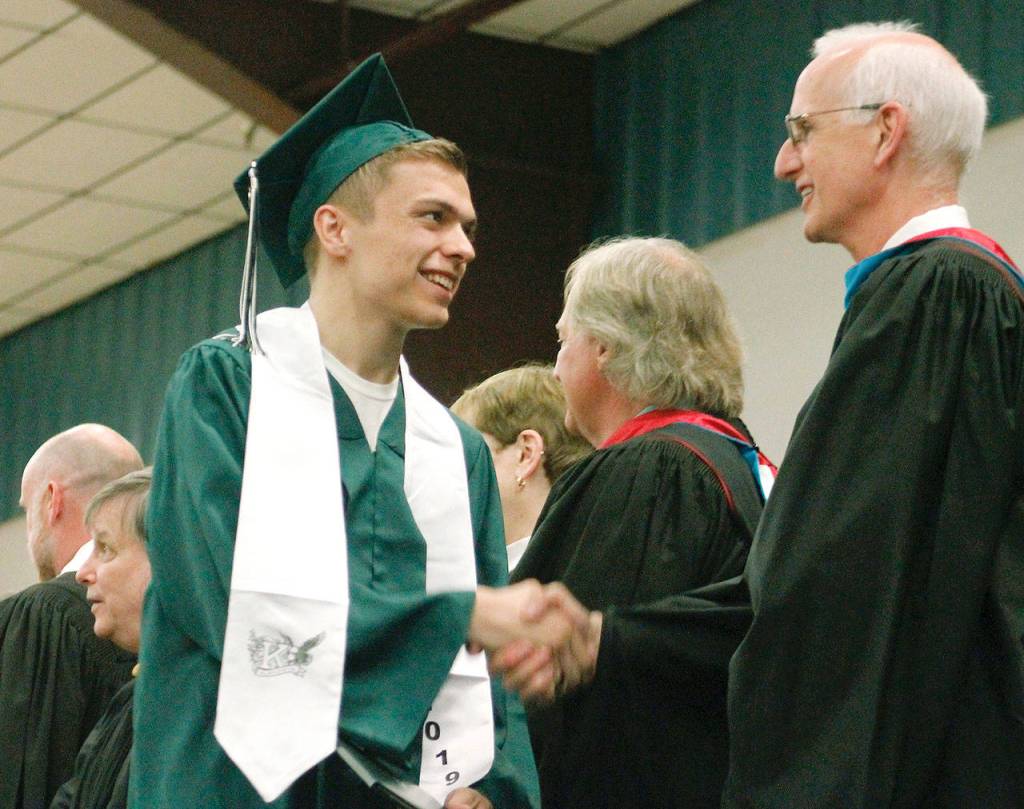 Graduates get their diploma and proceed out. (Mark Krulish/Kitsap News Group)