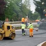 Paving crews work on laying the final layer of asphalt on Tremont Street just east of the South Kitsap Boulevard roundabout Tuesday night. (Bob Smith | Kitsap Daily News)