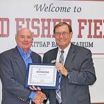 Former South Kitsap High School football coach Ed Fisher is congratulated on the athletic fields renaming by Karst Brandsma, South Kitsap School District superintendent. (SKSD photo)