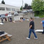 Courtesy photo                                Competitors try their hand at cornhole during preliminary tournament play earlier this month in Port Orchard, sponsored by Peninsula BevCo.