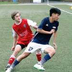 Former South Kitsap Wolf Grant Larson tries to put the brakes on his opponent. (Mark Krulish/Kitsap News Group)