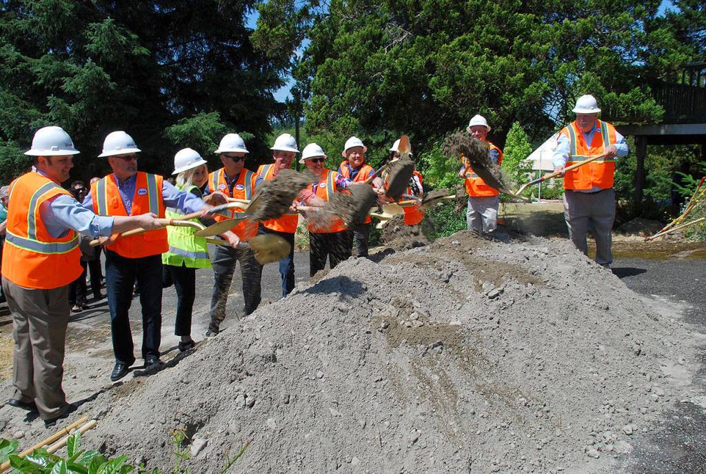 Port Orchard city officials and legislators, with ceremonial shovels in hand, turn dirt to signal the start of construction at the site of the Tremont Street project in July 2017. (Bob Smith | Kitsap News Group 2017)