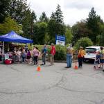 A lineup of residents attending the Tremont Street Widening Project completion ceremony line up for hot dogs, chips and cake. (Bob Smith | Kitsap Daily News)