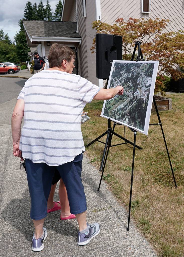 Community members attending the Tremont Street project completion ceremony on Friday look over an illustration set up for viewing. (Bob Smith | Kitsap Daily News)