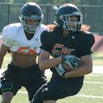 <em>Sophomore receiver Kalai Pasi catches a pass during a preseason practice. </em>                                Mark Krulish/Kitsap News Group