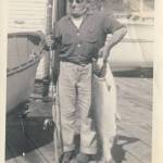 Anton Tony Holm holds up a salmon he caught while standing beside a Poulsbo Boat. Photo courtesy Matt Diehl.