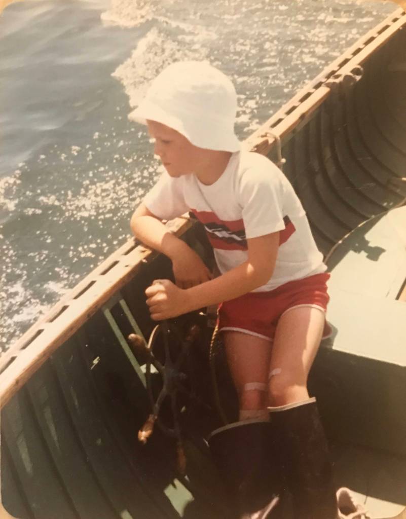 Matt Diehl helms his grandfathers Poulsbo Boat in 1982, at the age of 8. Photo courtesy Matt Diehl.