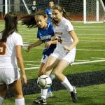 Kingstons Anastasia Horne (4) battles for a loose ball with Olympics Aalysia Mitchell. (Mark Krulish/Kitsap News Group)