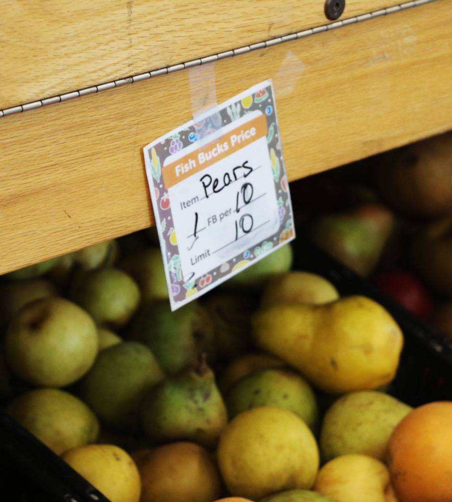 The food bank at Fishline distributes fish bucks which act as currency in the food bank allowing shoppers to get what they need. In this case, one fish buck would get them 10 pears due to the abundance, items that are not in abundance tend to cost more fish bucks.
