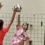 Klahowya junior Anna Bell fights for a ball at the net with Olympics Faith Harer (18) in their match on Thursday night. (Mark Krulish/Kitsap News Group)