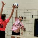 Klahowya junior Anna Bell fights for a ball at the net with Olympics Faith Harer (18) in their match on Thursday night. (Mark Krulish/Kitsap News Group)